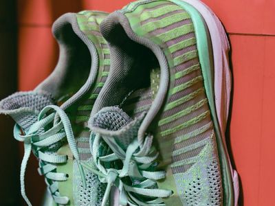 Pair of red running shoes on black background
