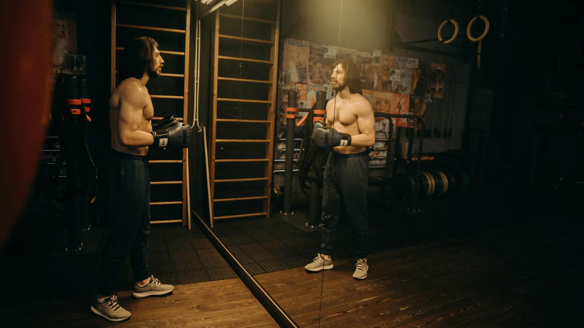 Person performing dynamic cardio movements in a dark studio